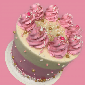 pink birthday cake with lots of frosting