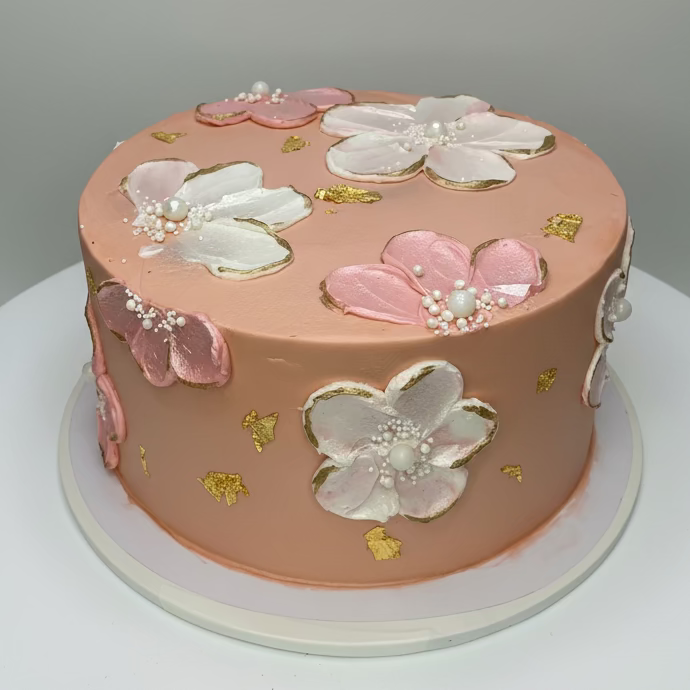 Decorative cake with floral designs on a white surface