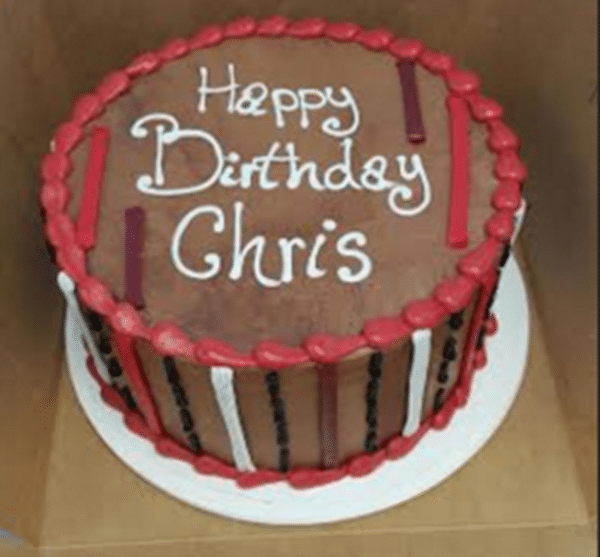 Man Cake, chocolate cake with various colored stripes on the side of the cake, topped with a special message