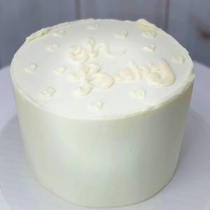 All white gender reveal cake with colored filling to match the baby's sex