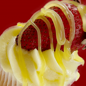 Cupcake with a fresh strawberry and lemon topping